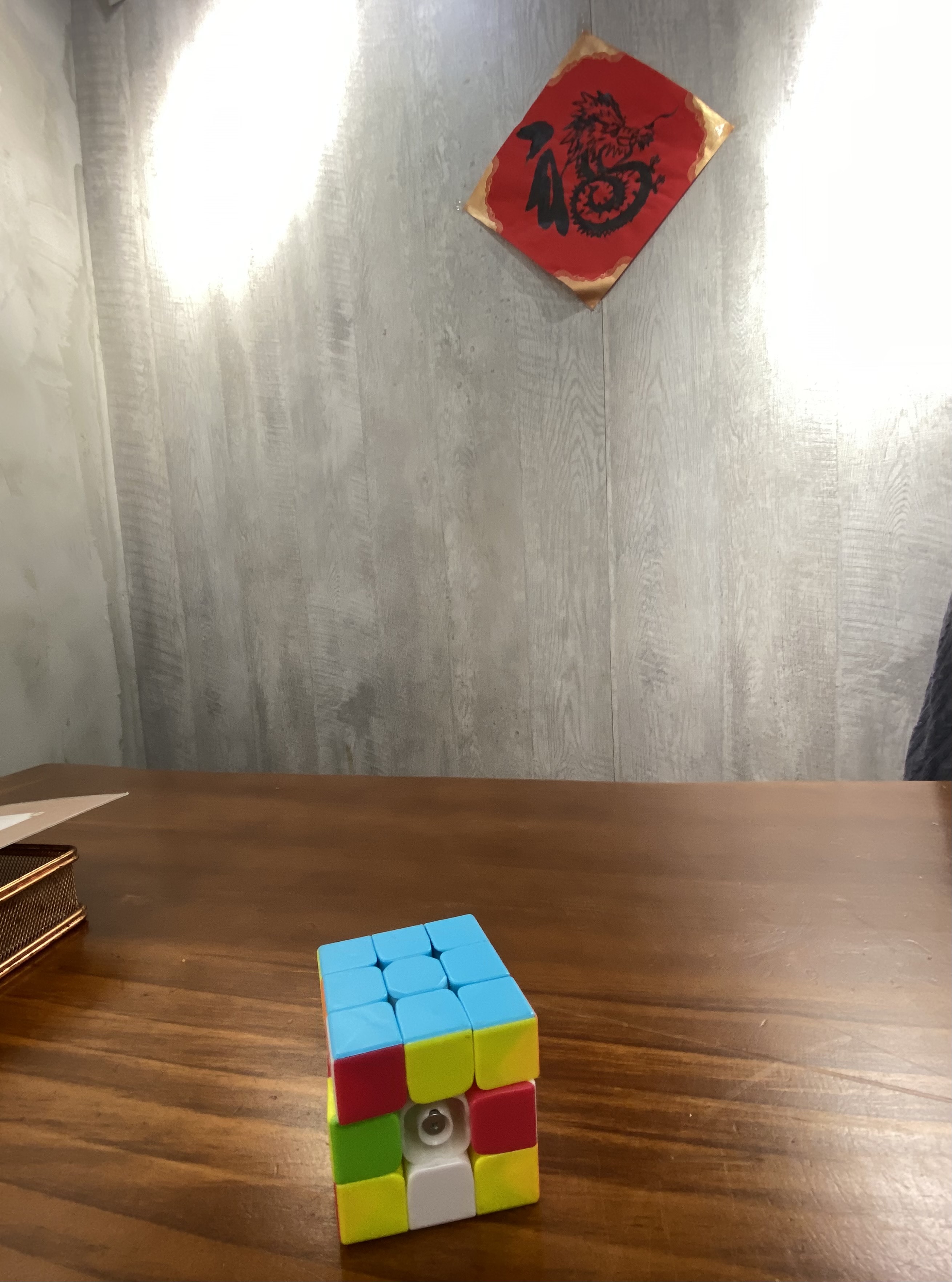 rubrik's cube on a cafe table with a red stylized abstract picture of the Chinese word happiness